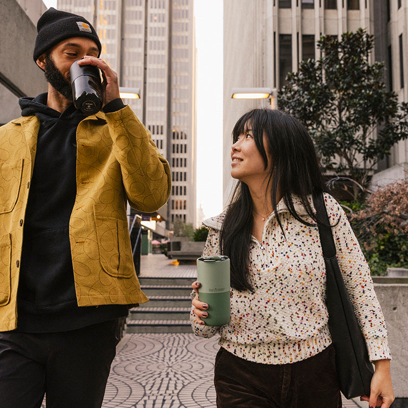 16oz-rise-tumbler-s8 16oz_rise_tumbler_black_iceberg_couple_drink_city_street_square.jpg
