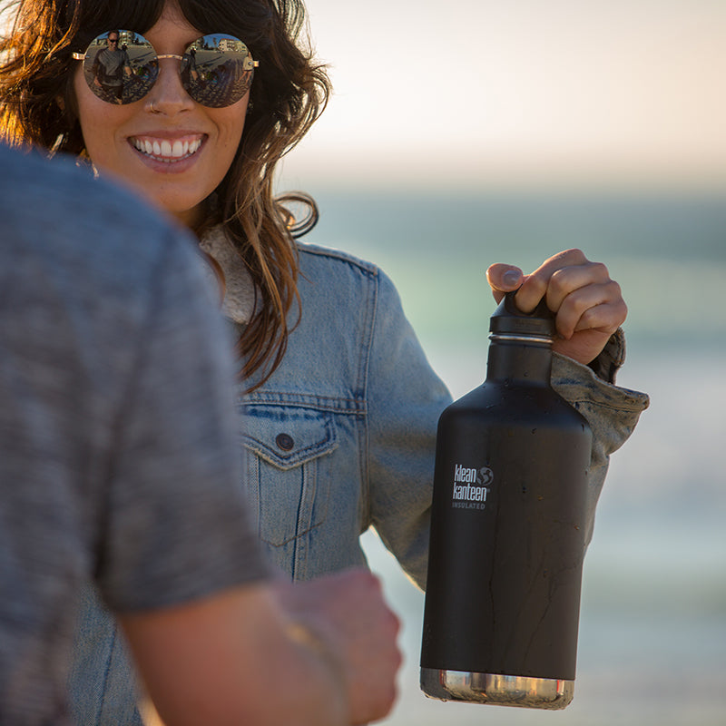 64oz-classic-with-loop-cap-m6 64oz_insulated_classic_black_beach_girl_hand_square.jpg